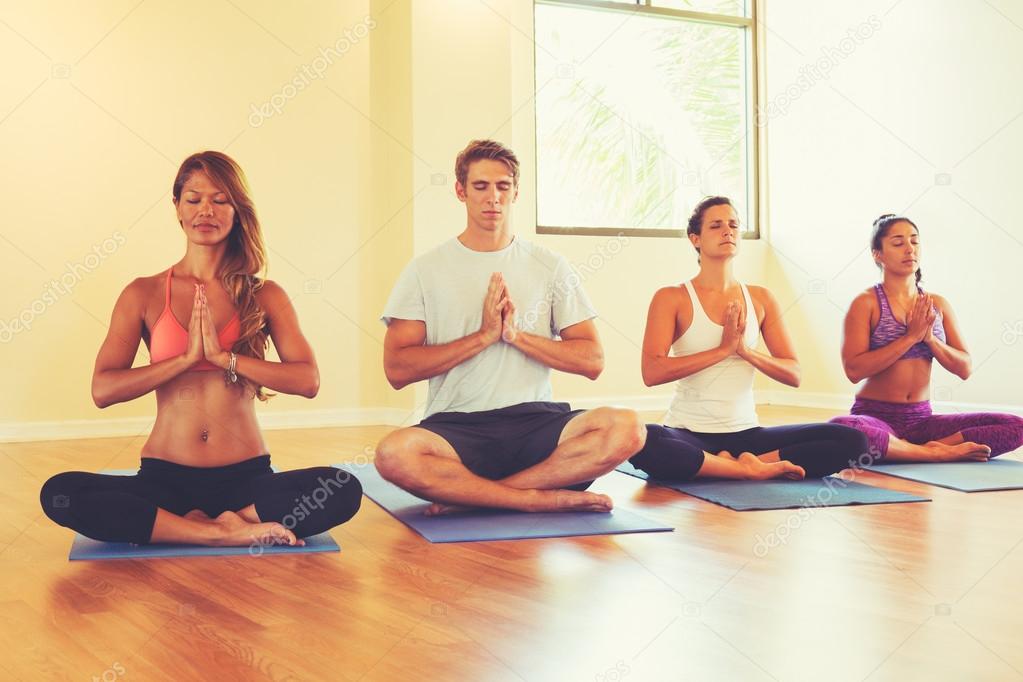People Relaxing and Meditating in Yoga Class. 