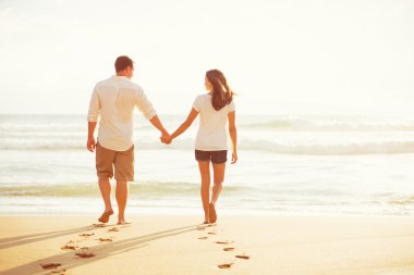 Couple Walking on the Beach at Sunset clipart
