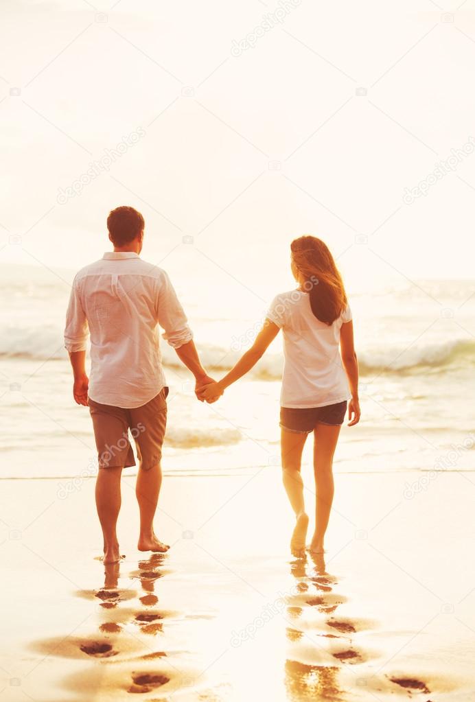 Couple Walking on the Beach at Sunset