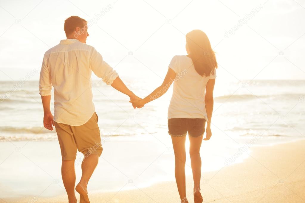 Couple Walking on the Beach at Sunset