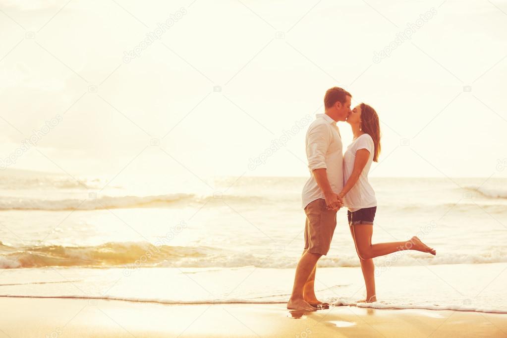 Romantic Couple Kissing on the Beach at Sunset