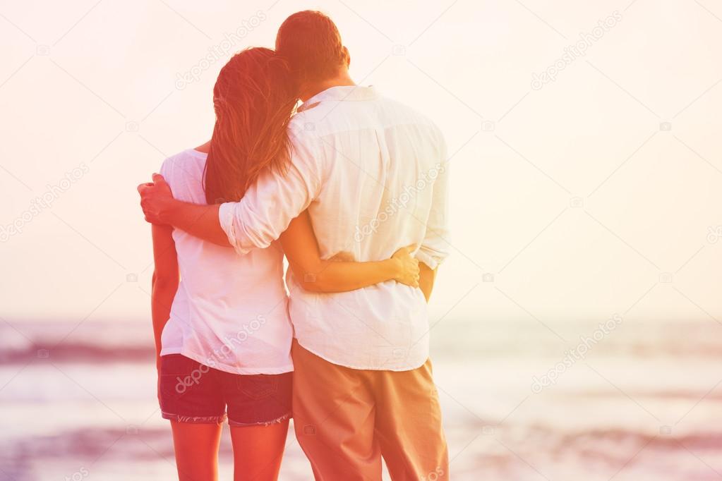 Romantic Couple Enjoying Beautiful Sunset at the Beach