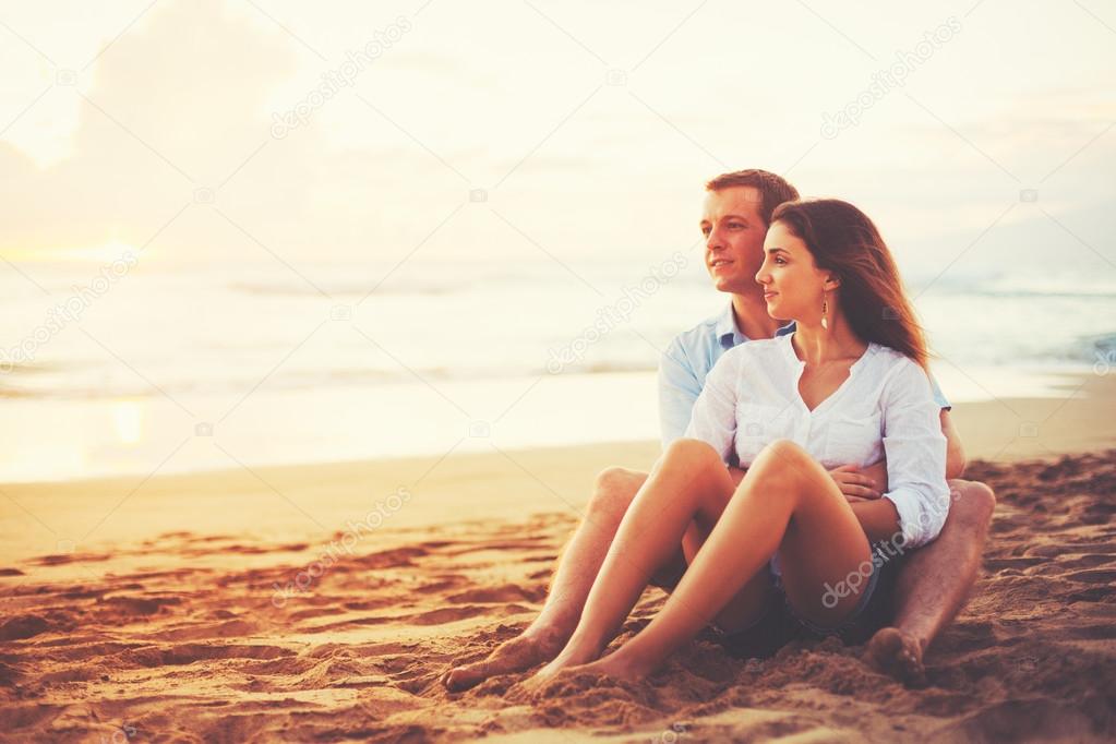 Romantic Couple Enjoying Beautiful Sunset at the Beach