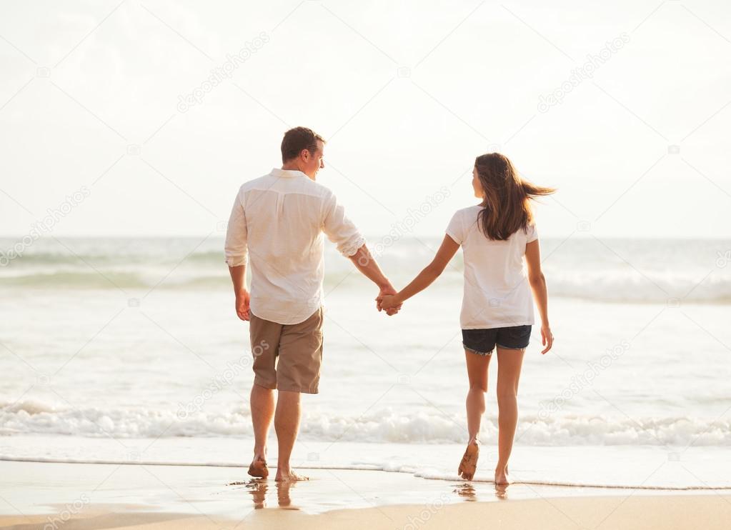 Romantic Young Couple on the Beach at Sunset