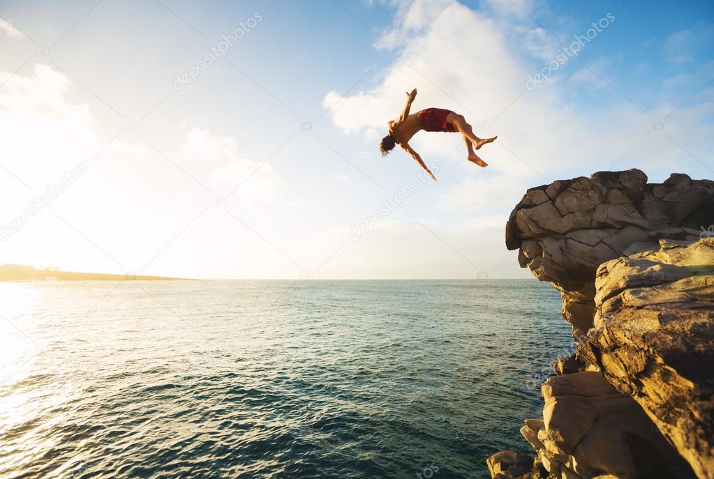 Cliff Jumping extreme at sunset Stock Photo by ©EpicStockMedia 91480384
