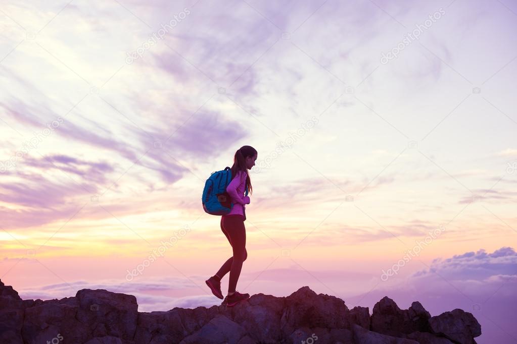 Woman Hiking in the Mountains at Sunset