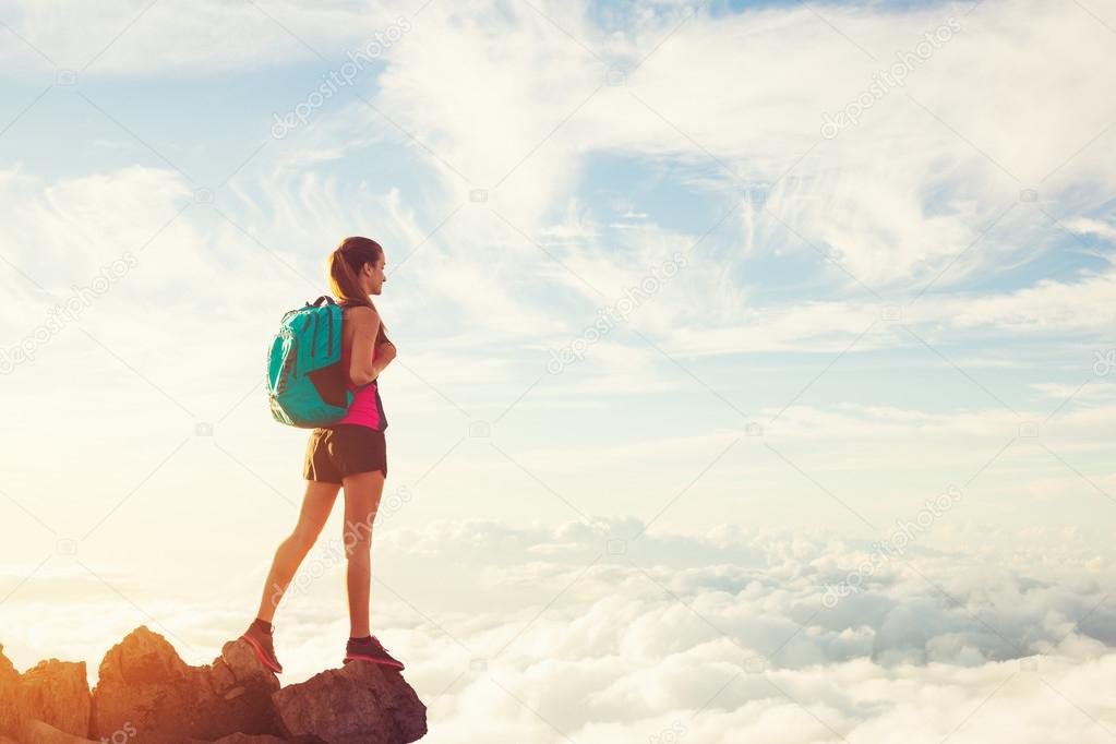 Woman Hiking in the Mountains at Sunset