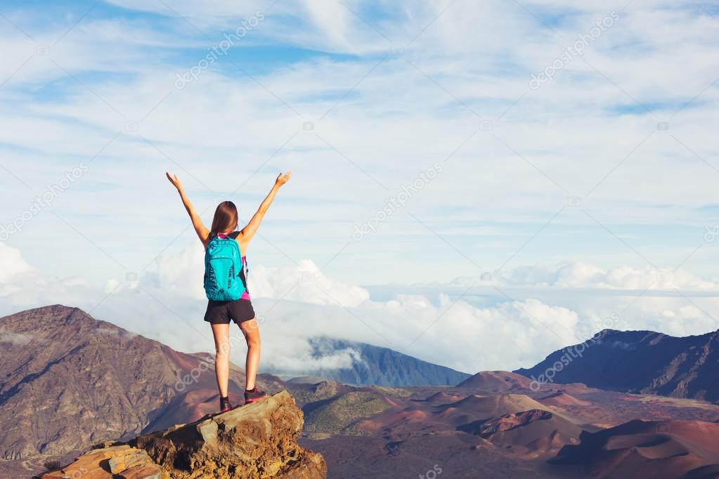 Young Woman with Backpack on Mountain Peak with Open Arms