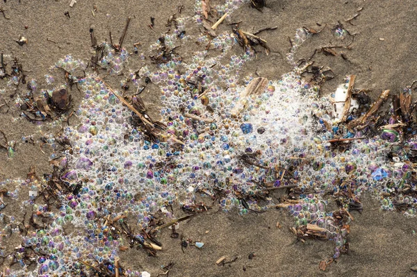 Polluted sea water on beach — Stock Photo, Image