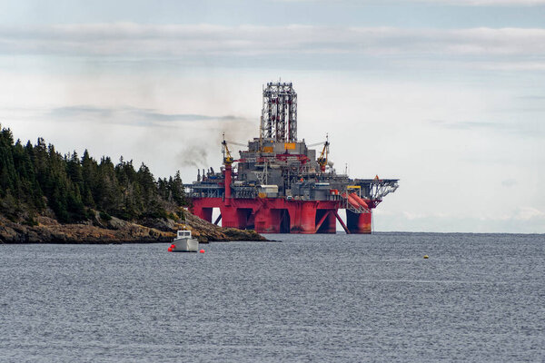 Deep water drill rig is moored near shore after finishing an exploration well, Newfoundland and Labrador, Canada.
