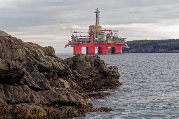 Deep water drill rig is moored near shore after finishing an exploration well, Newfoundland and Labrador, Canada.
