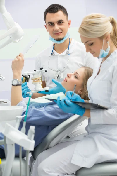 Modern dental clinic, young dentist working — Stock Photo, Image