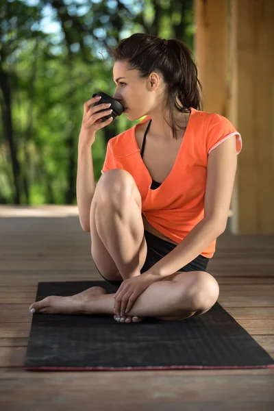 Yoga girl with cup — стокове фото