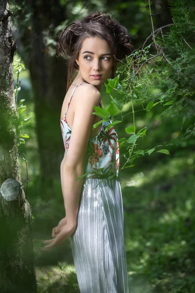 Милая девушка в платье рядом с деревом — стоковое фото