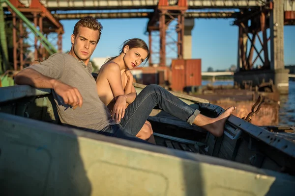 Sexy couple in old boat — Stock Photo, Image