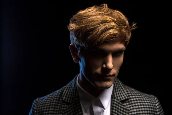 Portrait of red-haired handsome guy on a black background — Stock Photo, Image