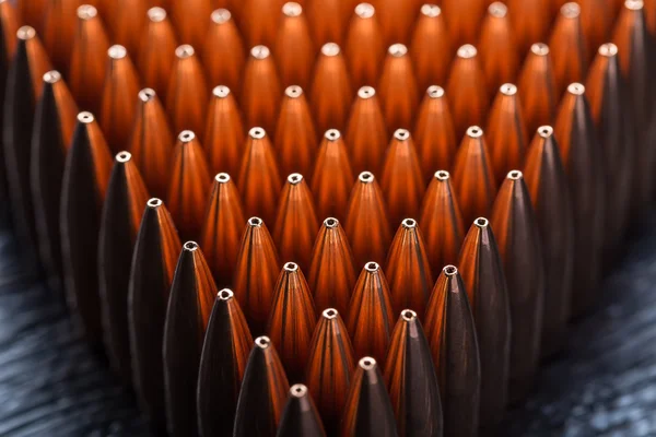 Macro shot of copper bullets that are in many rows to form a tri — Stock Photo, Image