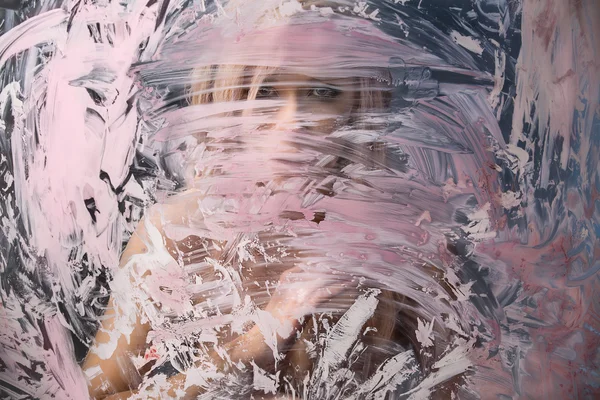 Portrait of seminude blonde through the glass smeared pink clay — Stock Photo, Image