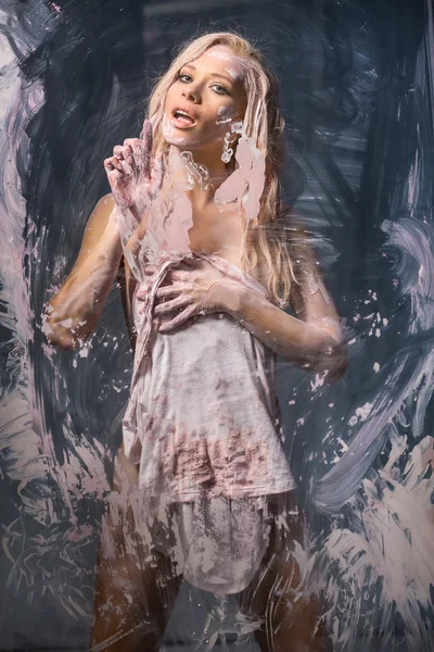 Portrait of seminude blonde through the glass smeared pink clay — Stock Photo, Image