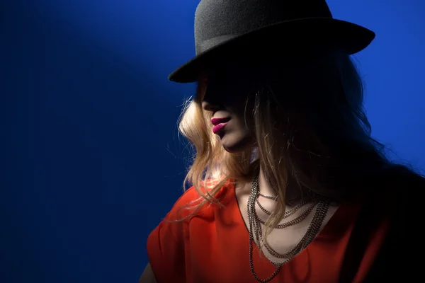 Contrast portrait of sexy blonde in a red hat — Stock Photo, Image