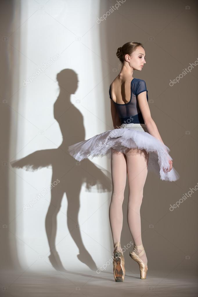 Full growth portrait of the graceful ballerina in a studio 