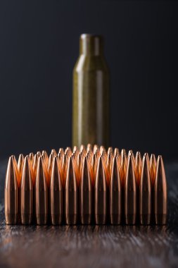Macro shot of copper bullets that are in many rows to form a tri clipart