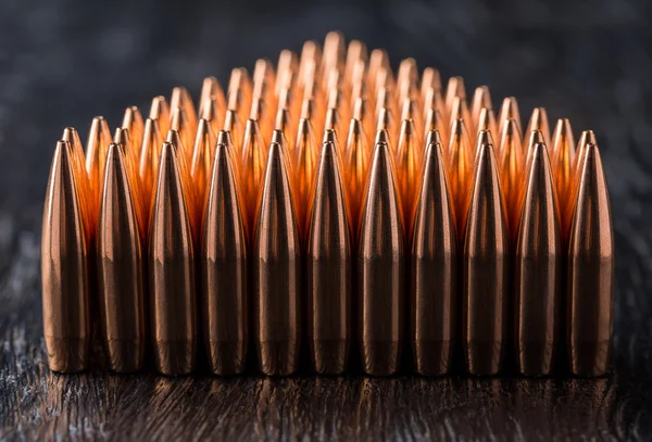 Macro shot of copper bullets that are in many rows to form a tri — Stock Photo, Image