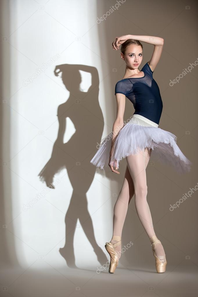 Full growth portrait of the graceful ballerina in a studio 