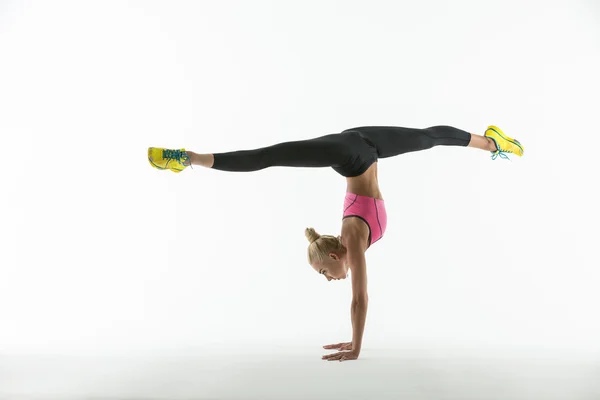 Gymnastice dělat cvičení ve studiu. — Stock fotografie