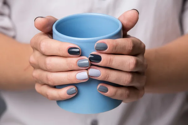 Female hands with blue cup — 스톡 사진