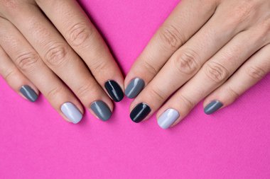 Delicate female hands with a stylish neutral manicure