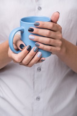 Female hands with blue cup