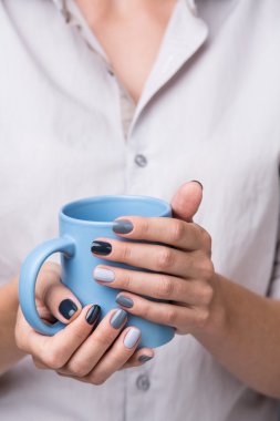 Female hands with blue cup