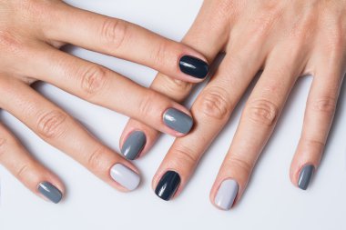Hand with a stylish gray manicure isolated on white background