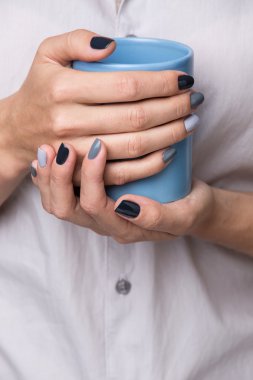 Female hands with blue cup