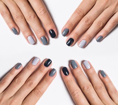 Hand with a stylish gray manicure isolated on white background