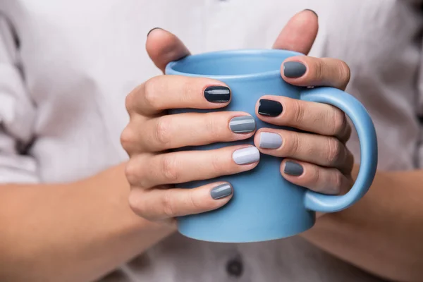 Female hands with blue cup — 스톡 사진