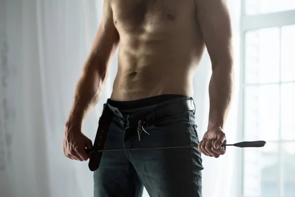 Handsome guy topless with whip BDSM — Stock Photo, Image