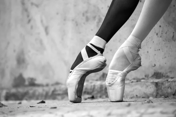 Dokulu beton wal bir arka plan üzerinde balerin ayak yakın çekim — Stok fotoğraf