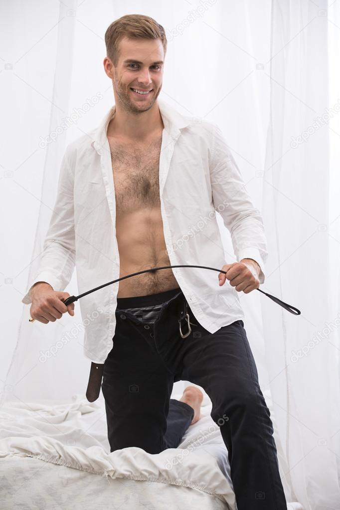 Handsome guy with whip BDSM