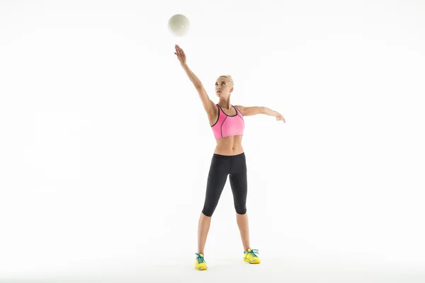 Художественная гимнастка делает упражнения с мячом в студии . — стоковое фото
