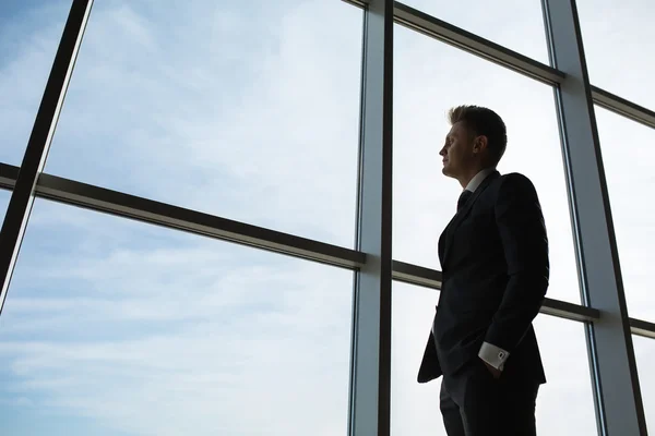 Stylish business man in the background of a large window — Stock Photo, Image