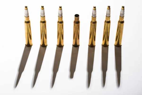 Macro shot of bullet casings on a white studio background — Stock Photo, Image