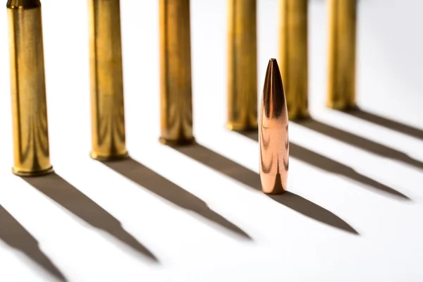 Macro shot of bullet casings on a white studio background — Stock Photo, Image