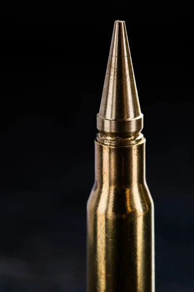 Top of the rifle cartridge on a dark background — 스톡 사진