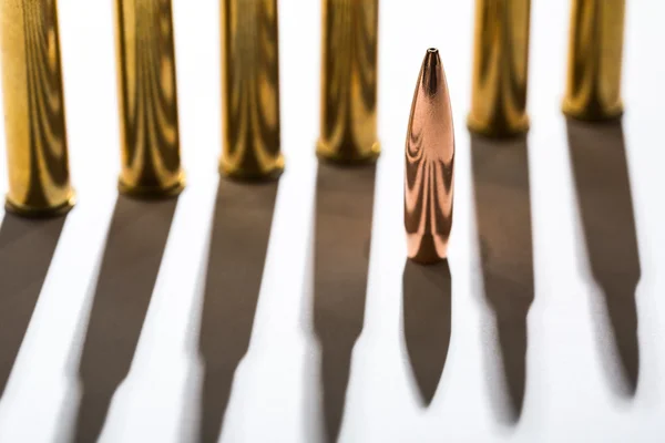 Macro shot of bullet casings on a white studio background — Stock Photo, Image