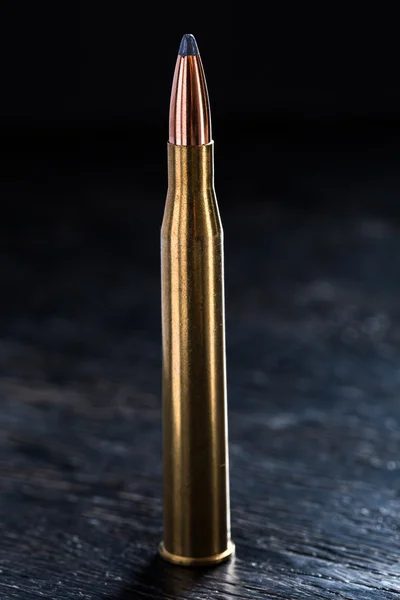 Large-caliber cartridge on a dark background — Stock Photo, Image