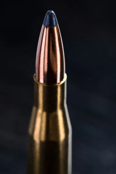 Large-caliber cartridge on a dark background — Stock Photo, Image