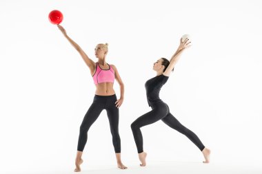 Two girls with balls