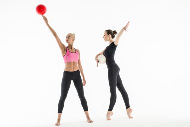 Two girls with balls